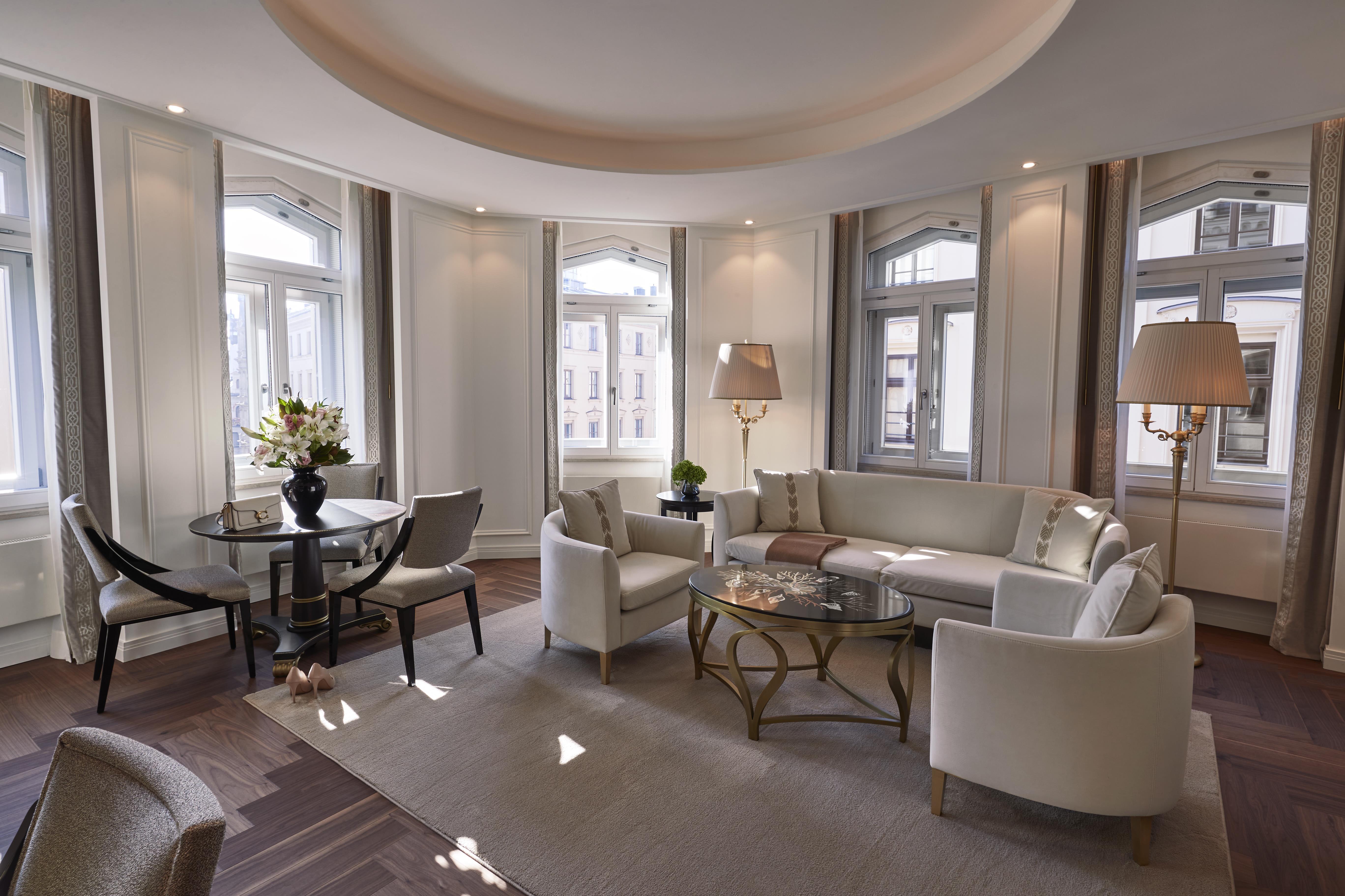 Elegant Signature Two Bedroom Suite living room with floor-to-ceiling windows at Hotel Vier Jahreszeiten Kempinski München